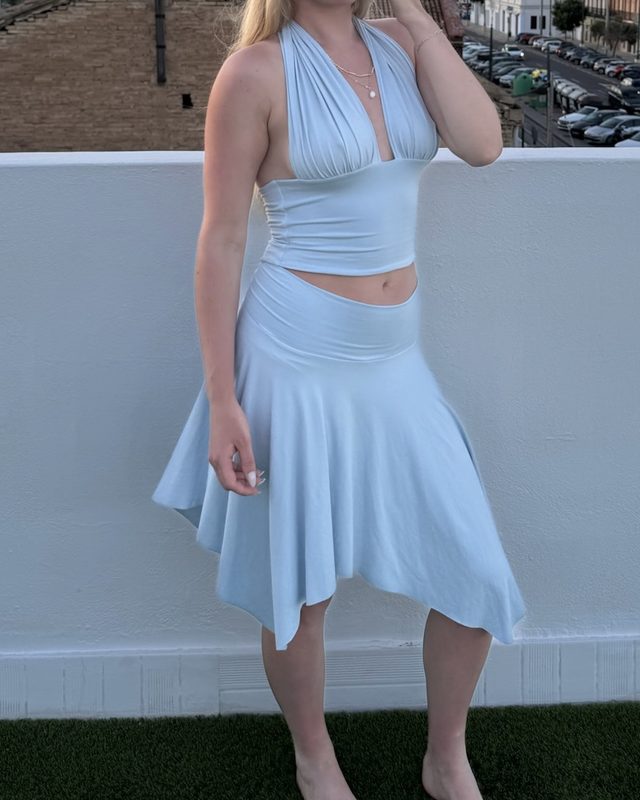 Rachel wearing a pale blue jersey handkerchief skirt, the hem falling in soft points to mid-calf